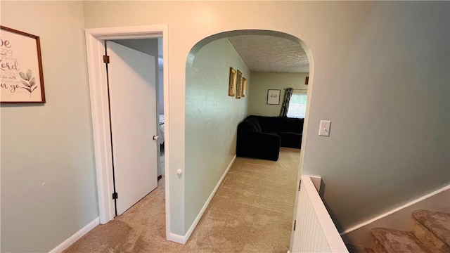 324 Paul Dr, Lower Burrell, PA 15068 - corridor with carpet flooring, arched walkways, a textured ceiling, and stairs