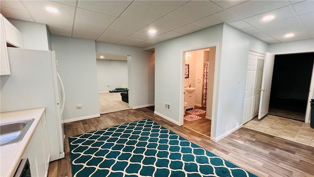 324 Paul Dr, Lower Burrell, PA 15068 - kitchen with white cabinets, light wood-style floors, recessed lighting, and a paneled ceiling