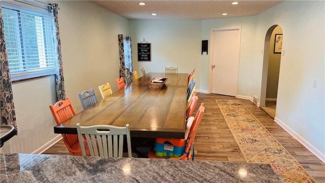324 Paul Dr, Lower Burrell, PA 15068 - dining space with arched walkways, wood finished floors, and recessed lighting
