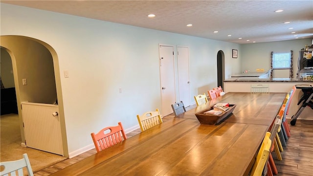 324 Paul Dr, Lower Burrell, PA 15068 - dining area with arched walkways, recessed lighting, wood finished floors, and a textured ceiling