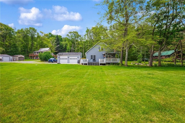 604 Lake Shore Rd, Lake Stonycreek, PA 15541 - view of grassy yard featuring an outbuilding, a deck, and a detached garage
