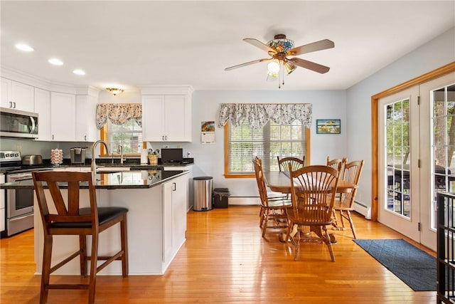 604 Lake Shore Rd, Lake Stonycreek, PA 15541 - kitchen featuring stainless steel appliances, dark countertops, ceiling fan, white cabinetry, and recessed lighting