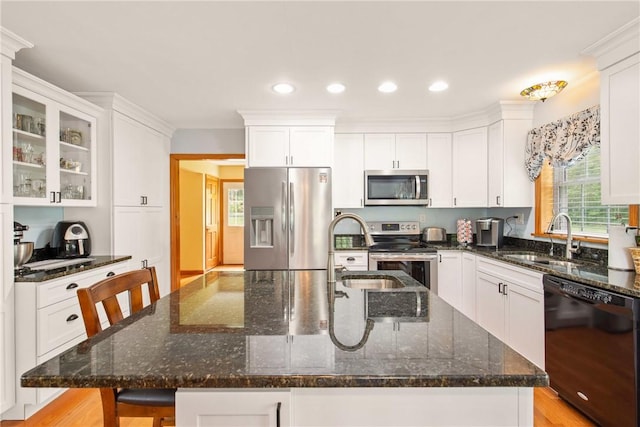 604 Lake Shore Rd, Lake Stonycreek, PA 15541 - kitchen with stainless steel appliances, white cabinetry, recessed lighting, dark stone counters, and a kitchen breakfast bar