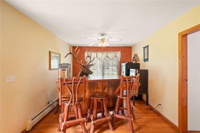 604 Lake Shore Rd, Lake Stonycreek, PA 15541 - indoor dry bar featuring baseboard heating, ceiling fan, and light wood-style floors
