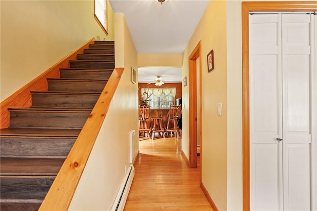 604 Lake Shore Rd, Lake Stonycreek, PA 15541 - stairs with wood finished floors, a ceiling fan, and a baseboard heating unit