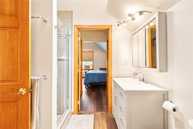 604 Lake Shore Rd, Lake Stonycreek, PA 15541 - bathroom with vaulted ceiling, a shower stall, wood finished floors, vanity, and connected bathroom