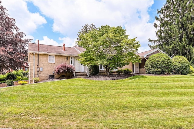 127 Mount Odin Dr, Hempfield Twp, PA 15601 - rear view of property featuring a lawn and brick siding