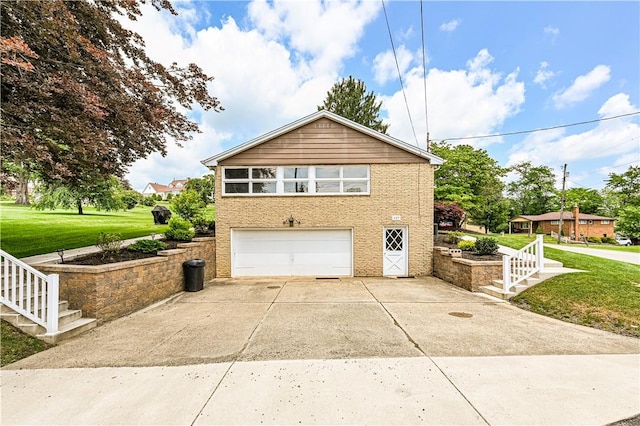 127 Mount Odin Dr, Hempfield Twp, PA 15601 - view of property exterior with concrete driveway, an attached garage, stairway, and a yard