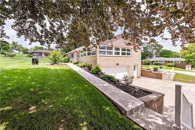 127 Mount Odin Dr, Hempfield Twp, PA 15601 - rear view of house featuring a yard, an attached garage, brick siding, and driveway