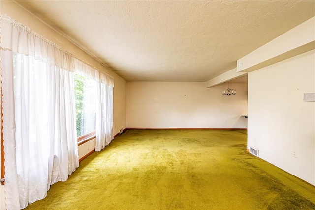 127 Mount Odin Dr, Hempfield Twp, PA 15601 - spare room with carpet floors, a textured ceiling, and a chandelier