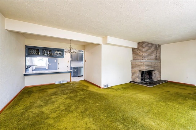 127 Mount Odin Dr, Hempfield Twp, PA 15601 - unfurnished living room featuring a textured ceiling, a chandelier, a brick fireplace, and carpet floors