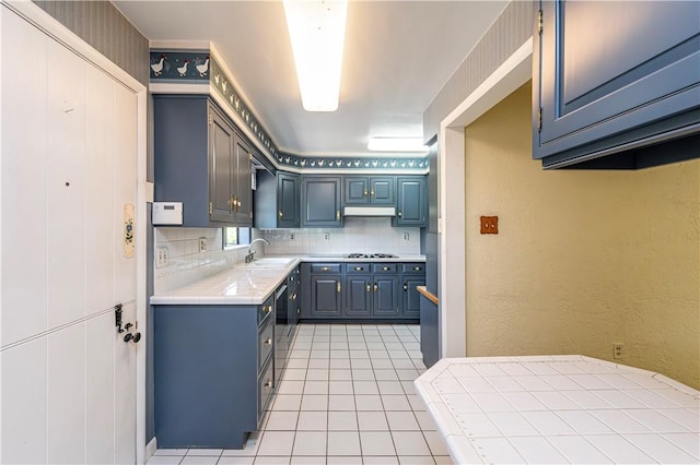 127 Mount Odin Dr, Hempfield Twp, PA 15601 - kitchen with light tile patterned flooring, tasteful backsplash, gas cooktop, tile counters, and a textured wall