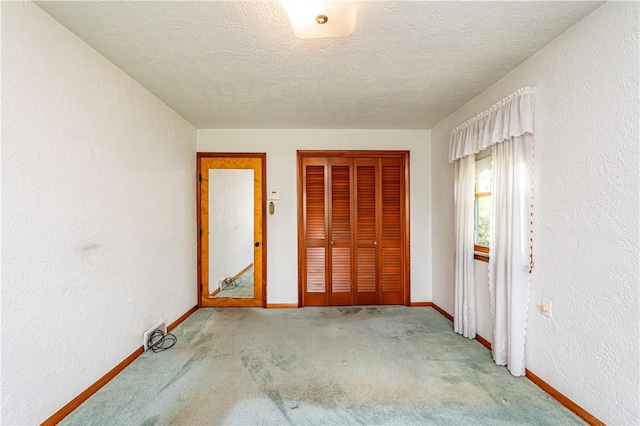127 Mount Odin Dr, Hempfield Twp, PA 15601 - carpeted entryway with a textured ceiling and a textured wall