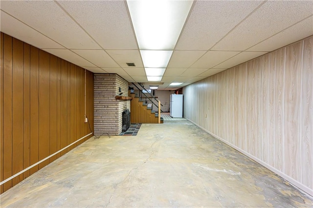127 Mount Odin Dr, Hempfield Twp, PA 15601 - finished basement with freestanding refrigerator, stairway, a paneled ceiling, and wooden walls