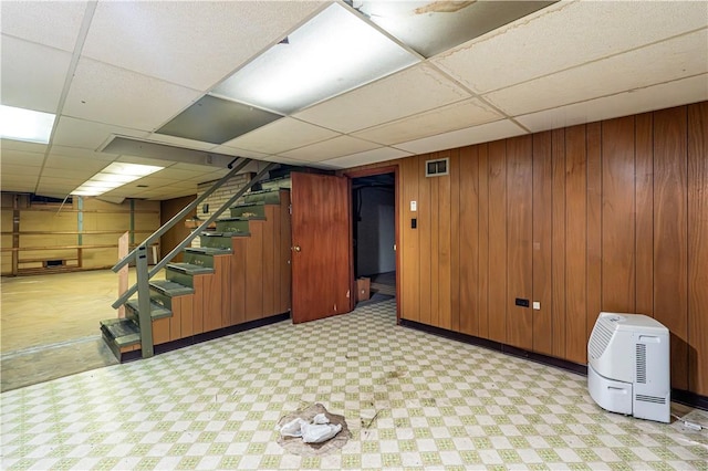 127 Mount Odin Dr, Hempfield Twp, PA 15601 - finished below grade area with a drop ceiling, stairway, light flooring, and wooden walls