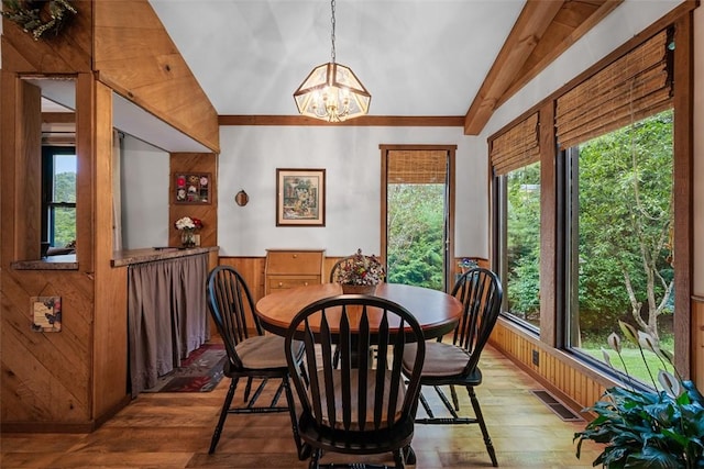 71 Mcclure Rd, West Deer, PA 15024 - dining room with vaulted ceiling, wood finished floors, a chandelier, plenty of natural light, and wood walls