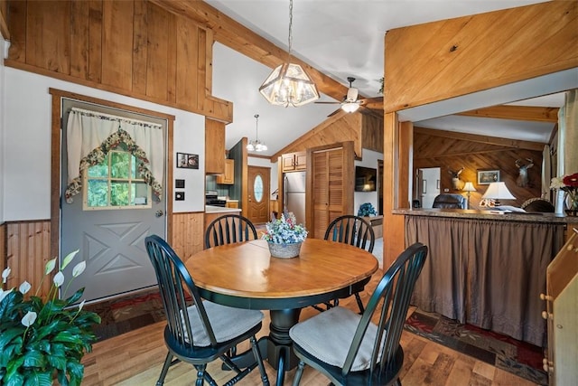 71 Mcclure Rd, West Deer, PA 15024 - dining room with wooden walls, wood finished floors, a chandelier, wainscoting, and a ceiling fan
