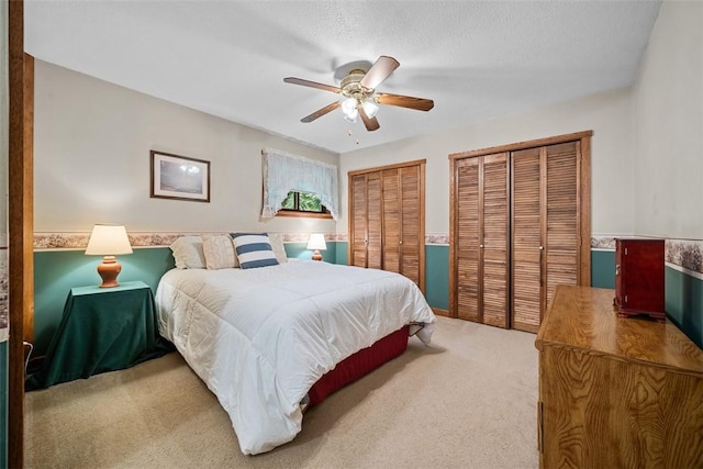 71 Mcclure Rd, West Deer, PA 15024 - carpeted bedroom featuring multiple closets, ceiling fan, and wainscoting