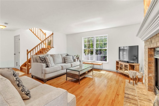 114 Franklin Oaks Dr, Franklin Twp, PA 16001 - living room with a fireplace, stairs, and light wood-type flooring