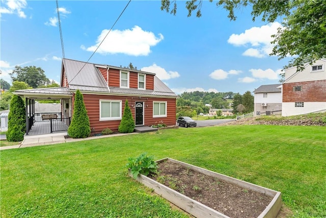 90 S Thompson Ln, North Huntingdon, PA 15642 - rear view of property featuring a vegetable garden, a yard, and a metal roof