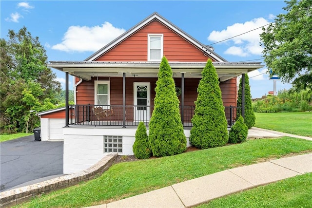 90 S Thompson Ln, North Huntingdon, PA 15642 - view of front of property with a porch, a front lawn, and a garage