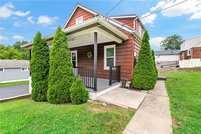 90 S Thompson Ln, North Huntingdon, PA 15642 - view of front of home with covered porch and a front yard