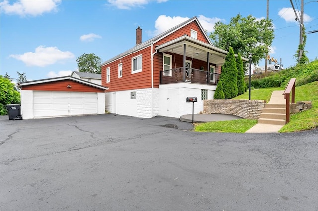 90 S Thompson Ln, North Huntingdon, PA 15642 - view of side of home with a chimney, an outbuilding, and a balcony