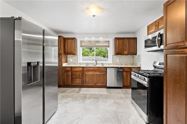 90 S Thompson Ln, North Huntingdon, PA 15642 - kitchen with stainless steel appliances, backsplash, light marble finish floors, and brown cabinetry