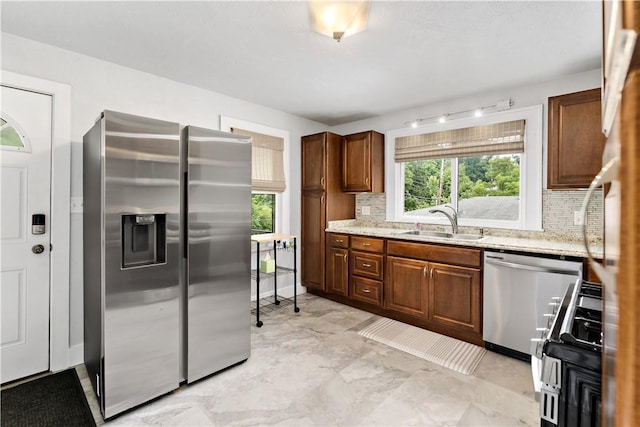90 S Thompson Ln, North Huntingdon, PA 15642 - kitchen with stainless steel appliances, tasteful backsplash, and light stone countertops
