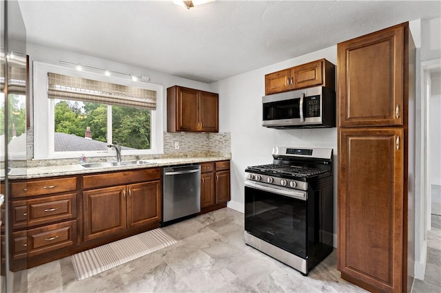 90 S Thompson Ln, North Huntingdon, PA 15642 - kitchen with stainless steel appliances, tasteful backsplash, light stone counters, and brown cabinets