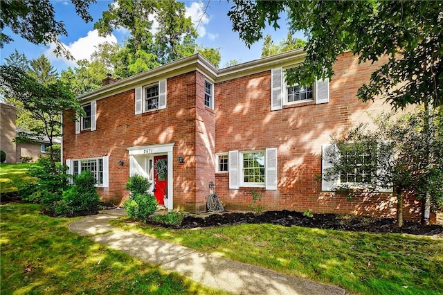 2671 Thorntree Dr, Saint Clair, PA 15241 - colonial inspired home with brick siding, a front lawn, and a chimney