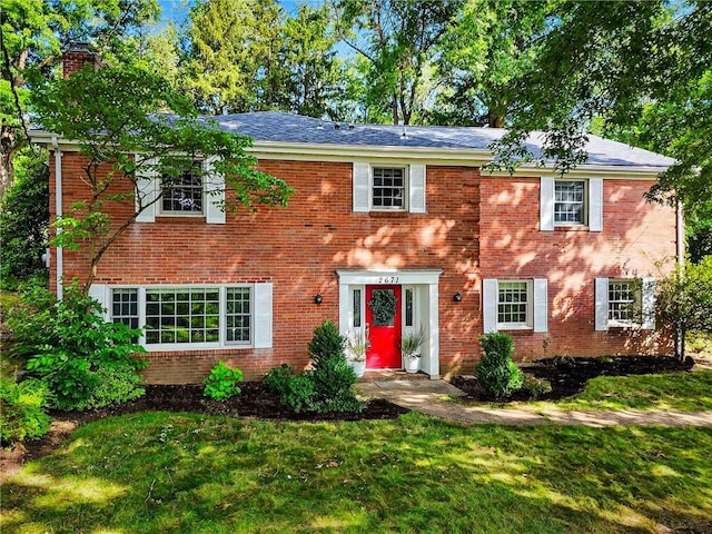 2671 Thorntree Dr, Saint Clair, PA 15241 - colonial inspired home with brick siding, a front yard, and a chimney