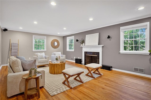 2671 Thorntree Dr, Saint Clair, PA 15241 - living area featuring wood finished floors, ornamental molding, recessed lighting, and a premium fireplace