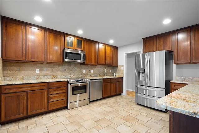 2671 Thorntree Dr, Saint Clair, PA 15241 - kitchen featuring stainless steel appliances, backsplash, light stone counters, glass insert cabinets, and recessed lighting