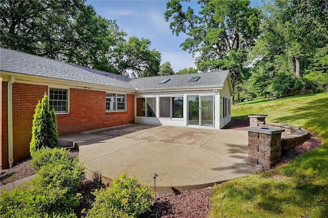 2671 Thorntree Dr, Saint Clair, PA 15241 - rear view of house featuring a patio area, brick siding, roof with shingles, and a lawn