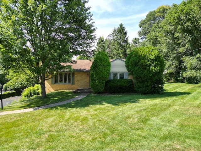 138 Demmel Dr, Peters Twp, PA 15317 - obstructed view of property featuring a front lawn and brick siding