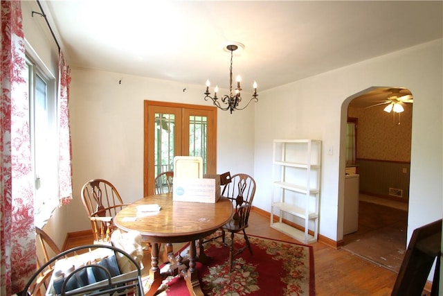 138 Demmel Dr, Peters Twp, PA 15317 - dining space with arched walkways, light wood finished floors, a chandelier, and wainscoting