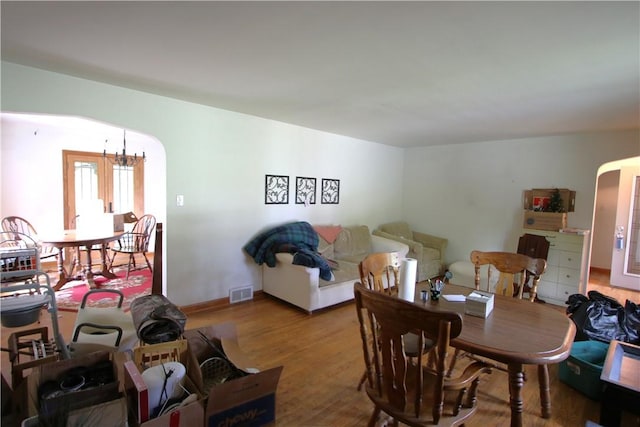 138 Demmel Dr, Peters Twp, PA 15317 - dining space with a chandelier, wood finished floors, and arched walkways