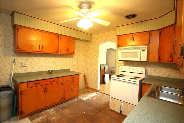 138 Demmel Dr, Peters Twp, PA 15317 - kitchen featuring white appliances, wallpapered walls, a ceiling fan, arched walkways, and brown cabinets