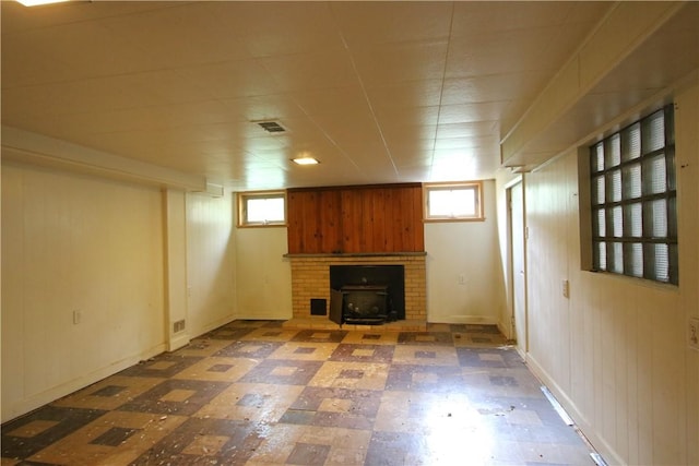 138 Demmel Dr, Peters Twp, PA 15317 - basement with tile patterned floors, a brick fireplace, healthy amount of natural light, and wooden walls