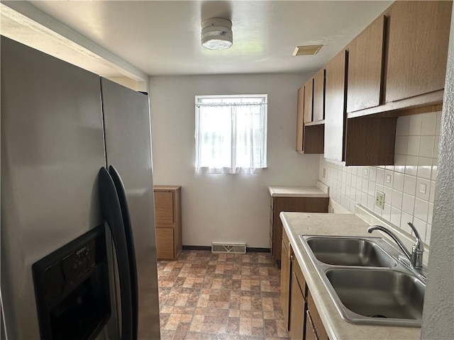 201 N 10th St, Connellsville, PA 15425 - kitchen featuring stainless steel fridge, decorative backsplash, and light countertops