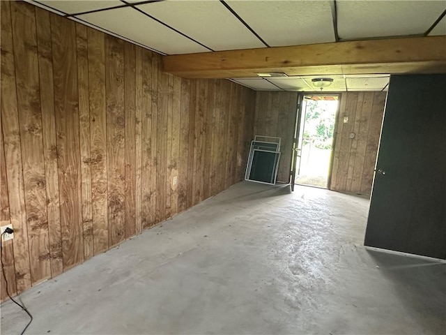 201 N 10th St, Connellsville, PA 15425 - unfurnished living room featuring wood walls and unfinished concrete floors