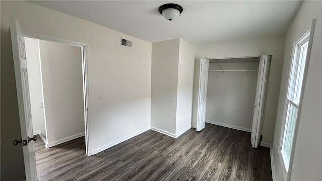 4010 Jane St, West Mifflin, PA 15122 - unfurnished bedroom with dark wood-style floors, a closet, and multiple windows