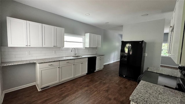 4010 Jane St, West Mifflin, PA 15122 - kitchen with black appliances, decorative backsplash, dark wood-style flooring, white cabinets, and light stone countertops