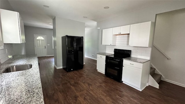 4010 Jane St, West Mifflin, PA 15122 - kitchen with black appliances, light stone countertops, and backsplash