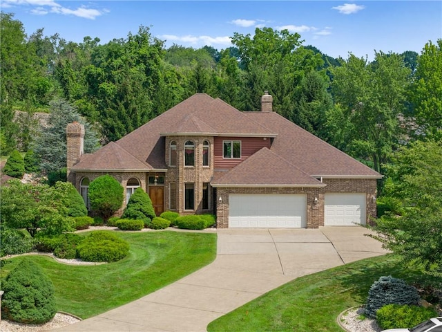 4 Hawthorne Ln, Penn Twp, PA 15642 - view of front of property featuring an attached garage, brick siding, concrete driveway, a front yard, and a chimney