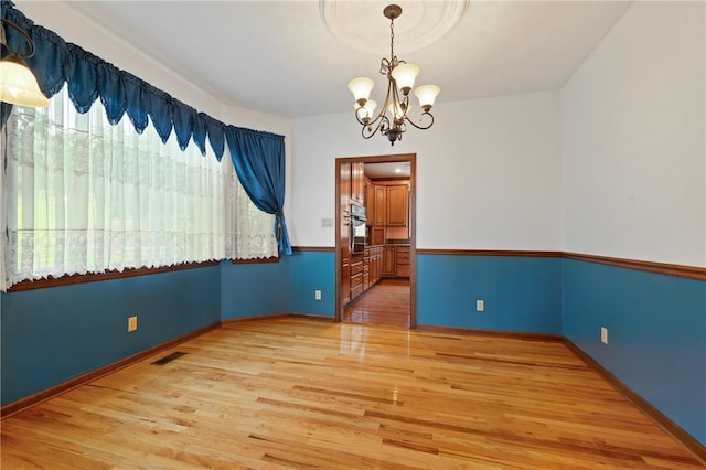4 Hawthorne Ln, Penn Twp, PA 15642 - unfurnished room with a chandelier and wood finished floors