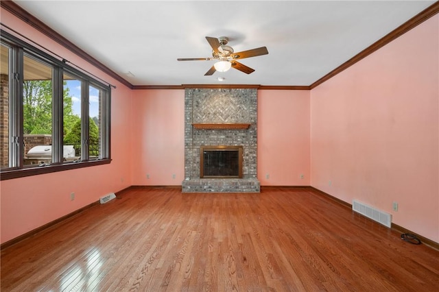 4 Hawthorne Ln, Penn Twp, PA 15642 - unfurnished living room with wood finished floors, a ceiling fan, a brick fireplace, and ornamental molding