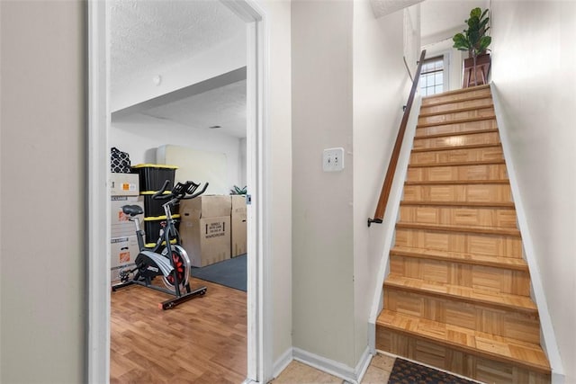 3269 Dawson St, Oakland, PA 15213 - stairs with wood finished floors and a textured ceiling