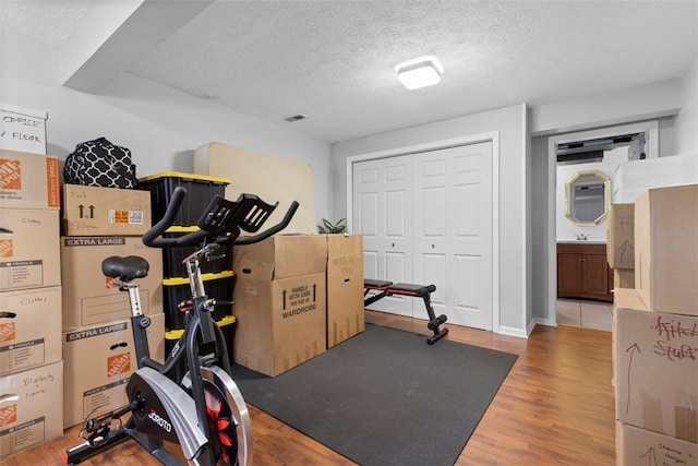 3269 Dawson St, Oakland, PA 15213 - exercise room featuring a textured ceiling and wood finished floors